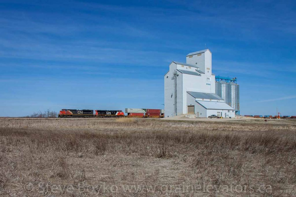 CN train passing the Norman, MB grain elevator, April 2016. Contributed by Steve Boyko.