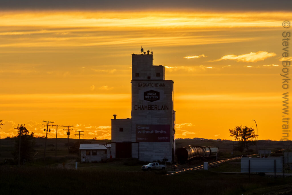 Grain elevator at Chamberlain Saskatchewan silhouetted by golden sunset